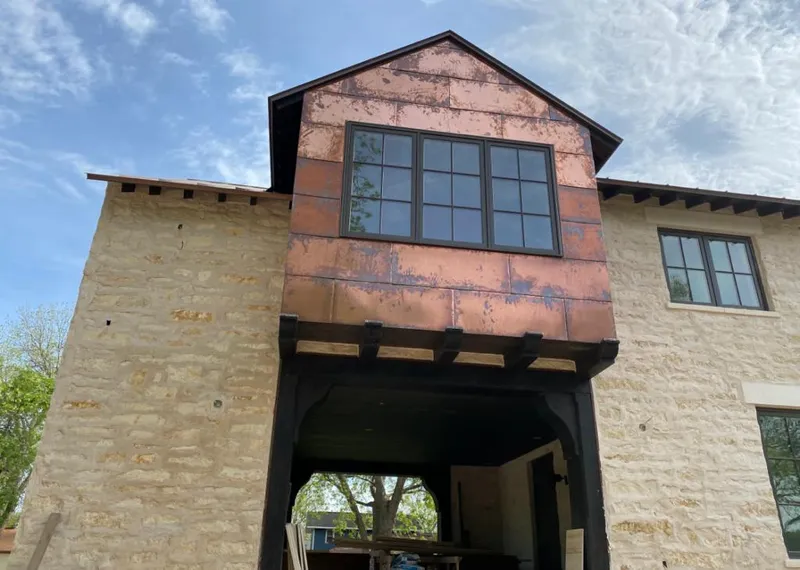 Copper metal panel facade on a stone building for Roof Repair in Crouch Mesa